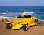 AUT 03 RK0008 08
1999 Plymouth Prowler Roadster Yellow Front 3/4 View On Sand By Ocean