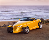 AUT 03 RK0011 03
1999 Plymouth Prowler Yellow Roadster 3/4 Front View On Sand By Ocean