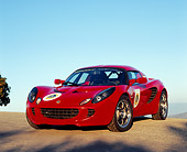 AUT 04 RK0122 01
2005 Lotus Elise Red 3/4 Front View On Pavement Hill Blue Sky