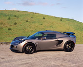 AUT 04 RK0137 01
2006 Lotus Exige Silver 3/4 Side View On Pavement By Grass Hills Blue Sky