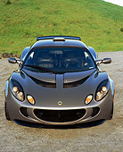 AUT 04 RK0140 02
2006 Lotus Exige Silver Head On View On Pavement By Grass Hills Blue Sky
