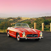 AUT 05 RK0147 04
Mercedes-Benz 300SL Convertible Red 3/4 Front View On Pavement By Hills At Dusk
