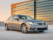 AUT 05 RK0606 01
2010 Mercedes-Benz 550 E Silver 3/4 Front View On Pavement By Building