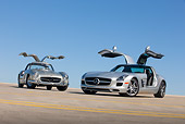 AUT 05 RK0659 01
1956 Mercedes-Benz 300 SL Gullwing Coupe And 2011 Mercedes-Benz SLS AMG Silver 3/4 Front View On Roof Of Parking Garage