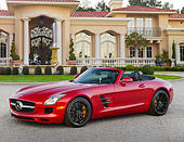 AUT 05 RK0693 01
2012 Mercedes-Benz SLS Roadster Red 3/4 Side View On Pavement By Mansion