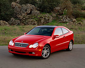 AUT 05 RK0241 03
2002 Mercedes-Benz C230 Kompressor Red 3/4 Front View On Pavement By Trees