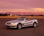 AUT 05 RK0292 01
2003 Mercedes SL55 AMG Roadster Silver 3/4 Front View On Pavement Mountains Background Filtered