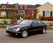 AUT 05 RK0302 07
2003 Mercedes E500W Sedan Black 3/4 Front View On Pavement By House