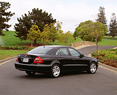 AUT 05 RK0307 06
2003 Mercedes E500W Sedan Black 3/4 Rear View On Pavement By Grass And Trees