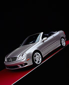 AUT 05 RK0387 01
2005 Mercedes-Benz CLK55 Convertible Silver Slanted Front 3/4 View On Red Floor Gray Line Studio