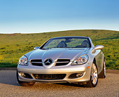 AUT 05 RK0396 01
2005 Mercedes-Benz SLK350 Convertible Silver 3/4 Front View On Pavement By Grass Hills