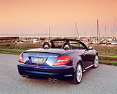 AUT 05 RK0425 02
2005 Mercedes-Benz SLK55 Roadster Blue 3/4 Rear View On Pavement By Harbor Filtered