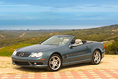 AUT 05 RK0486 01
2006 Mercedes-Benz SL500 Convertible Blue 3/4 Front View Mountains Background