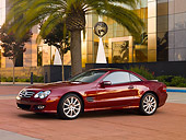 AUT 05 RK0505 01
2007 Mercedes-Benz SL550 Roadster Storm Red 3/4 Side View On Pavement By Building