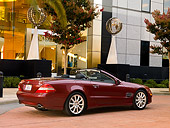 AUT 05 RK0506 01
2007 Mercedes-Benz SL550 Roadster Storm Red 3/4 Rear View On Pavement By Building