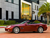 AUT 05 RK0507 01
2007 Mercedes-Benz SL550 Roadster Storm Red 3/4 Front View On Pavement By Building
