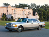 AUT 05 RK0577 01
1986 Mercedes-Benz 420 SEL Silver 3/4 Front View On Pavement By Building