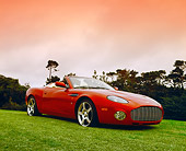 AUT 06 RK0022 02
2005 Aston Martin Zagato Roadster Burgundy 3/4 Front View On Grass By Hill