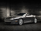 AUT 06 RK0146 01
2012 Aston Martin DBS Gray 3/4 Front View On Pavement By Dark Wooden Wall