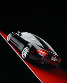 AUT 06 RK0064 06
2005 Aston Martin DB9 Coupe Black Slanted 3/4 Rear View On Red Floor Studio