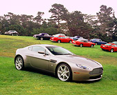 AUT 06 RK0073 15
2006 Aston Martin DB7 Vantage Gray 3/4 Side View On Grass By Other Aston Martin Cars