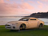 AUT 06 RK0097 01
Wood Model Of Aston Martin DB7 Zagato 3/4 Front View On Grass By Water Trees Sky