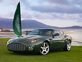 AUT 06 RK0098 01
2003 Aston Martin DB7 Zagato Green 3/4 Front View On Grass By Flag Water Mountains