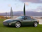 AUT 06 RK0103 01
2003 Aston Martin DB7 Zagato Green 3/4 Front View On Grass By Flag Water Mountains