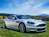 AUT 06 RK0107 01
2008 Aston Martin DBS Silver 3/4 Front View On Grass By Trees Blue Sky