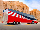 AUT 07 BK0010 01
1989 Peterbilt Big Rig Red And Black 3/4 Rear View On Road By Red Rock