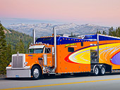 AUT 07 RK0052 01
1985 Peterbilt 359 Orange And Blue 3/4 Side View On Road In Mountains