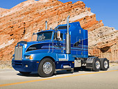 AUT 07 RK0053 01
1989 Kenworth T600 Big Rig Blue 3/4 Side View On Road By Red Rock