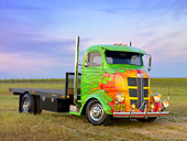 AUT 07 RK0070 01
1938 GMC COE Flatbed Truck Green With Flames 3/4 Front View On Grass By Vineyard