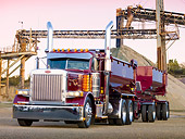 AUT 07 RK0072 01
1990 Peterbilt 379 Dark Rose Metallic 3/4 Front View On Pavement By Structure