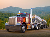 AUT 07 RK0074 01
1987 Peterbilt 379 Dark Rose Metallic 3/4 Front View On Gravel By Evergreen Trees