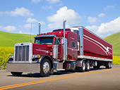 AUT 07 RK0090 01
2002 Peterbilt 379 Semi Red 3/4 Front View On Road By Grassy Hills