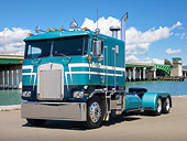 AUT 07 RK0095 01
1984 Kenworth K100 Semi Green 3/4 Front View On Pavement By Water And Bridge