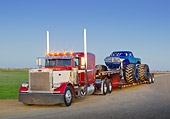 AUT 07 RK0192 01
1999 Peterbilt 379 Red, White And Blue And 2011 Dodge Ram Monster Truck Black With Blue Flames On Dirt Road