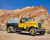 AUT 07 RK0367 01
1928 Mack AP Yellow With 1919 Fairbanks Morse 2 Cylinder 75 HPS Black On Trailer 3/4 Front View In Desert