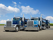AUT 07 RK0371 01
1999 Peterbilt 379 And 2007 Peterbilt Legacy Class 379 Blue 3/4 Front View On Pavement