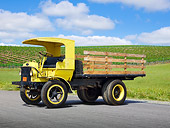AUT 07 RK0374 01
1922 Autocar 5 Ton Yellow 3/4 Front View On Pavement By Vineyard