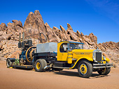 AUT 07 RK0385 01
1928 Mack AP Yellow With 1919 Fairbanks Morse 2 Cylinder 75 HPS Black On Trailer 3/4 Front View In Desert