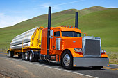 AUT 07 RK0393 01
1996 Peterbilt 379 Orange 3/4 Front View On Road By Grassy Hills