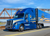 AUT 07 RK0407 01
2014 Freightliner Cascadia Evolution Blue 3/4 Front View On Road By Bridge