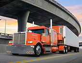 AUT 07 RK0411 01
2007 Western Star LowMax Orange 3/4 Front View On Road Under Overpass