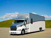 AUT 07 RK0020 01
Transporter Semi Truck 3/4 Front View On Pavement By Grass Hills