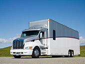 AUT 07 RK0021 01
Transporter Semi Truck 3/4 Front View On Pavement By Grass Hills