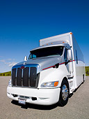 AUT 07 RK0022 01
Transporter Semi Truck 3/4 Front View On Pavement By Grass Hills