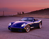 AUT 08 RK0014 06
2000 Panoz Esperante Prototype Blue 3/4 Front View On Pavement Hills Purple And Pink Sky