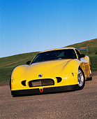 AUT 08 RK0031 02
2000 Panoz GTS Yellow Low Front 3/4 View On Pavement By Grass Hills Blue Sky